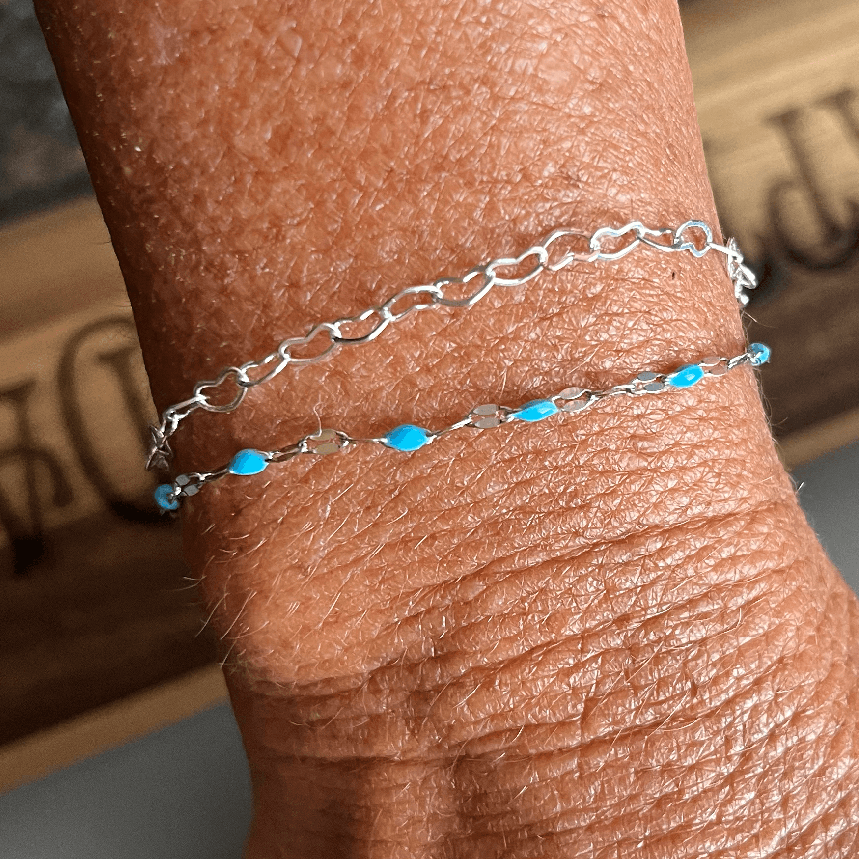 Multiple permanent jewelry bracelets made by Dark Desire Window Tint and Vinyl
